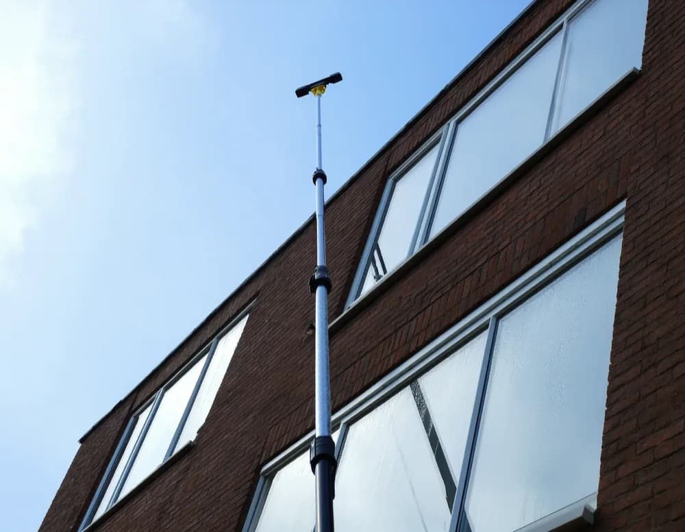 A telescopic pole reaching up to the upper windows of a Mannheim apartment building